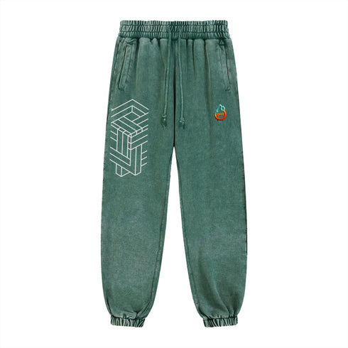 Green sweatpants with geometric design and small logo on a white background