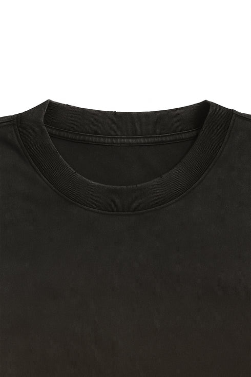 Close-up of a black t-shirt collar on a white background