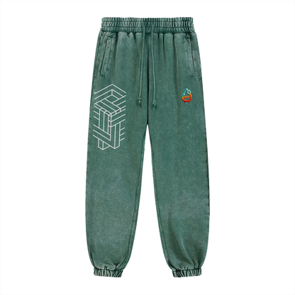 Green sweatpants with geometric design and small logo on a white background
