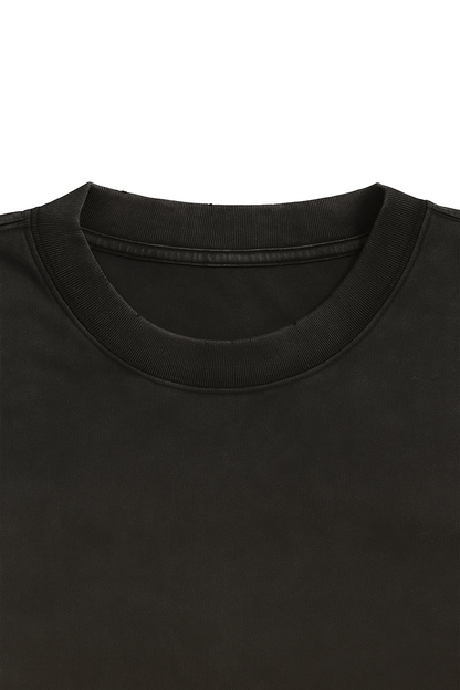 Close-up of a black t-shirt collar on a white background