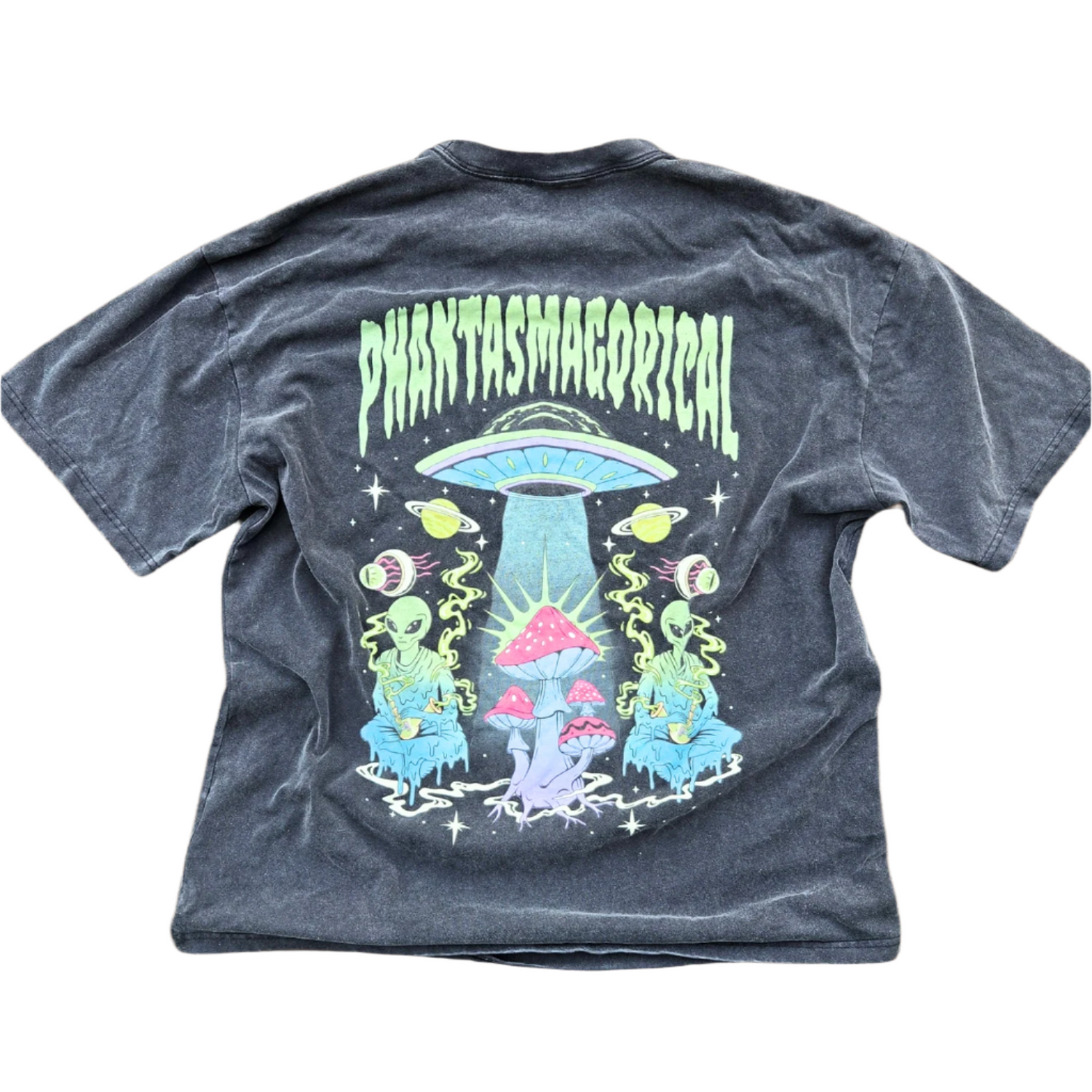 A black vintage heavyweight t-shirt with a graphic print in the center featuring a spaceship and various celestial bodies, with the word 'PHANTASMAGORICAL' above it.
