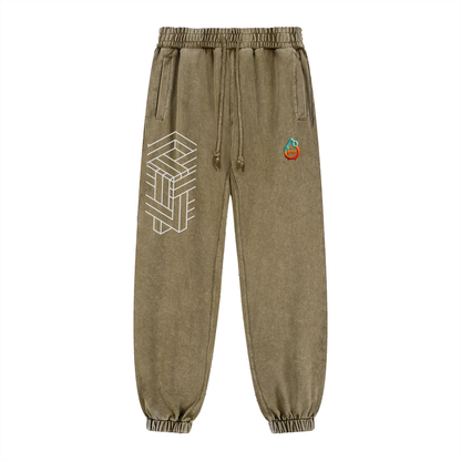 Khaki sweatpants with geometric design and colorful logo on a white background