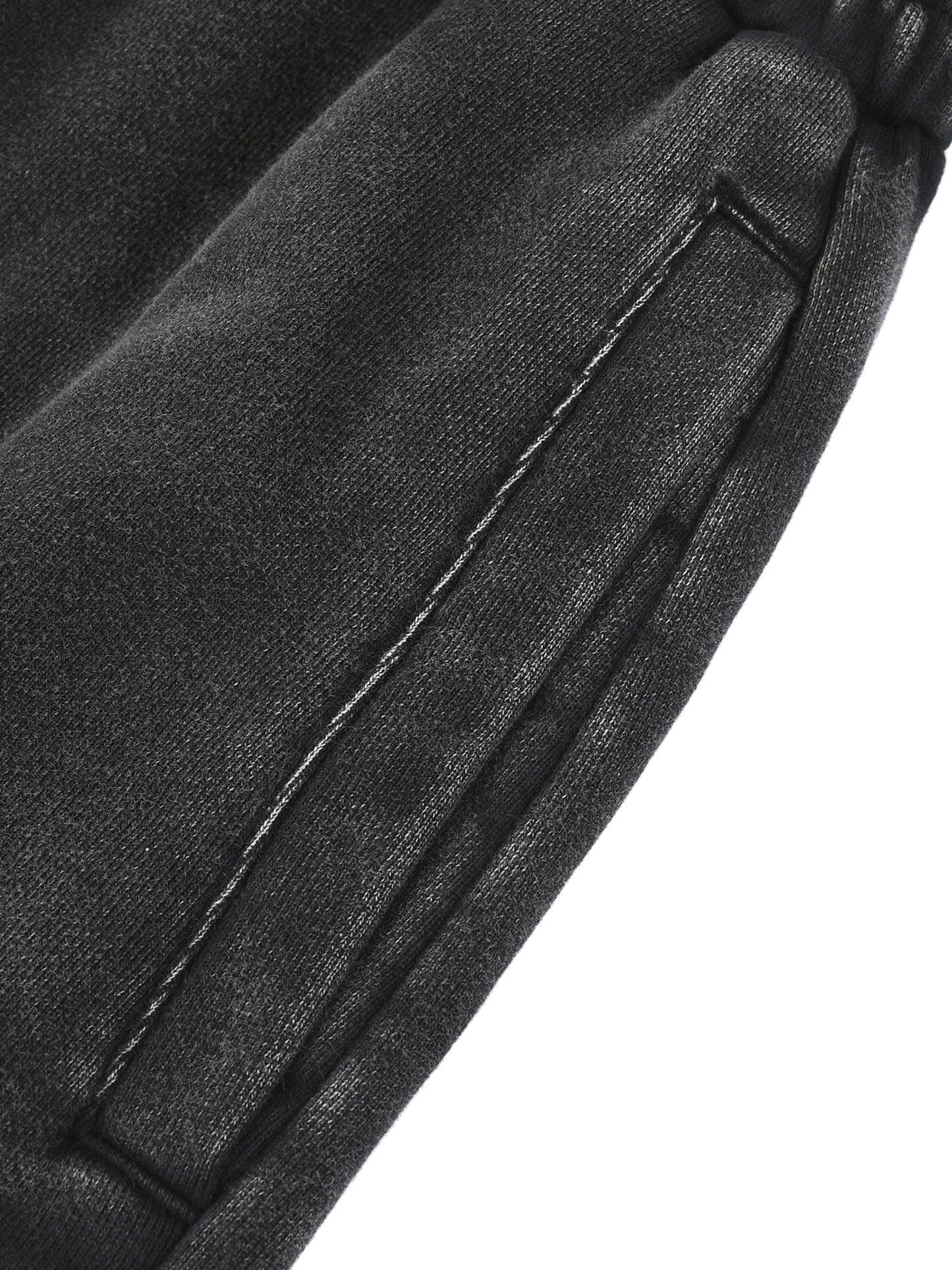 Close-up of a black leather jacket with stitching detail on a white background