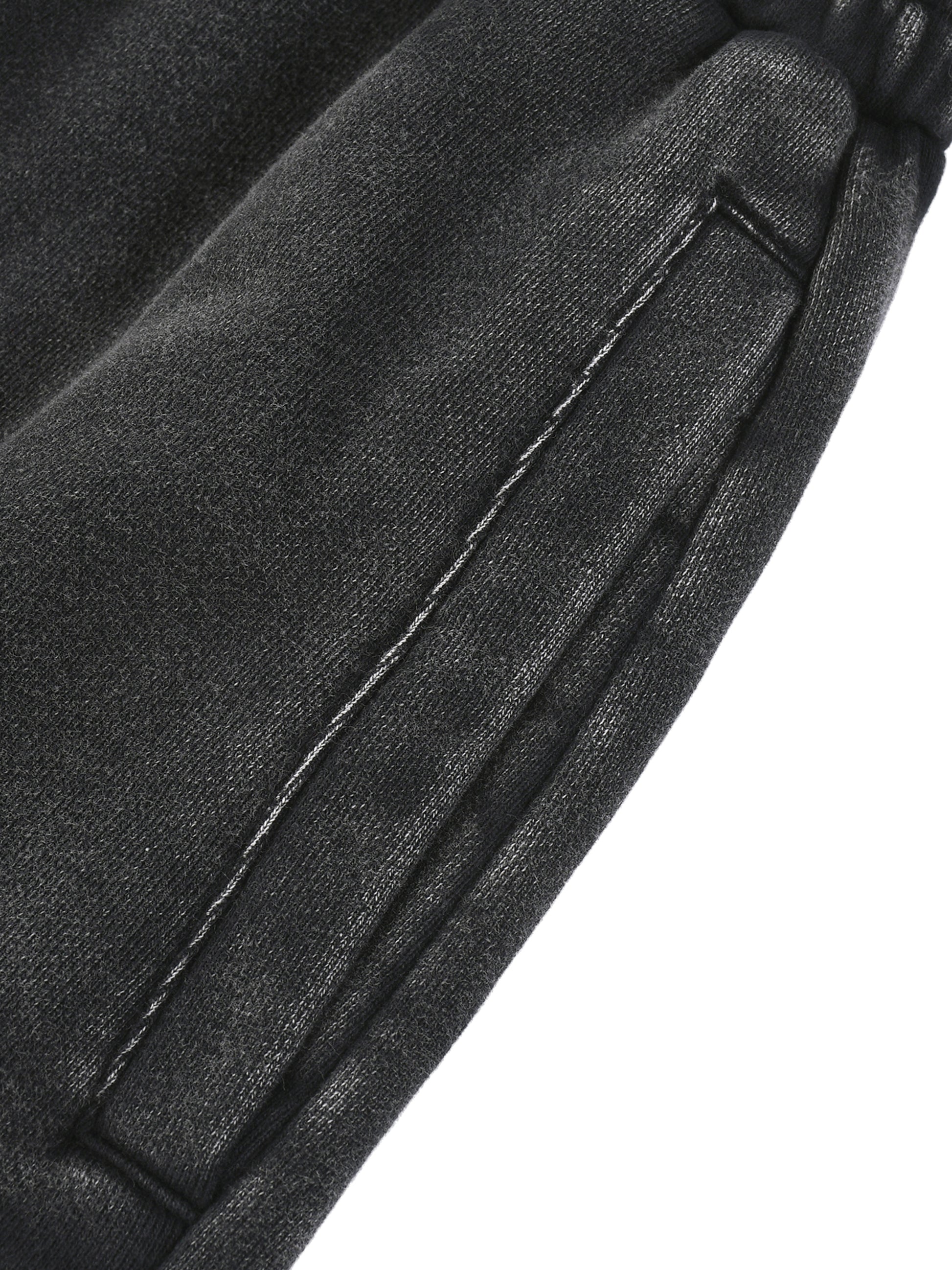 Close-up of a black leather jacket with stitching detail on a white background