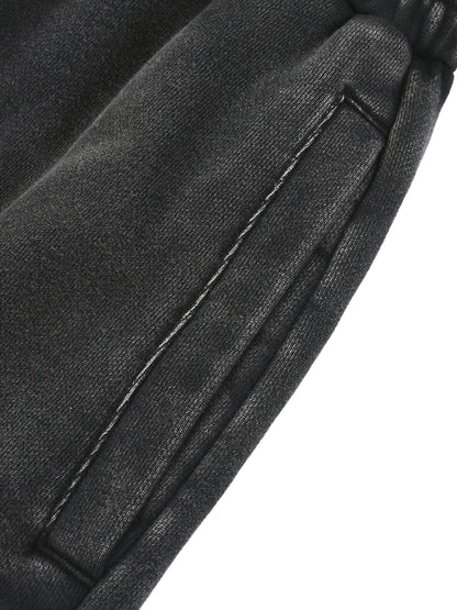 Close-up of a black leather jacket with stitching detail on a white background