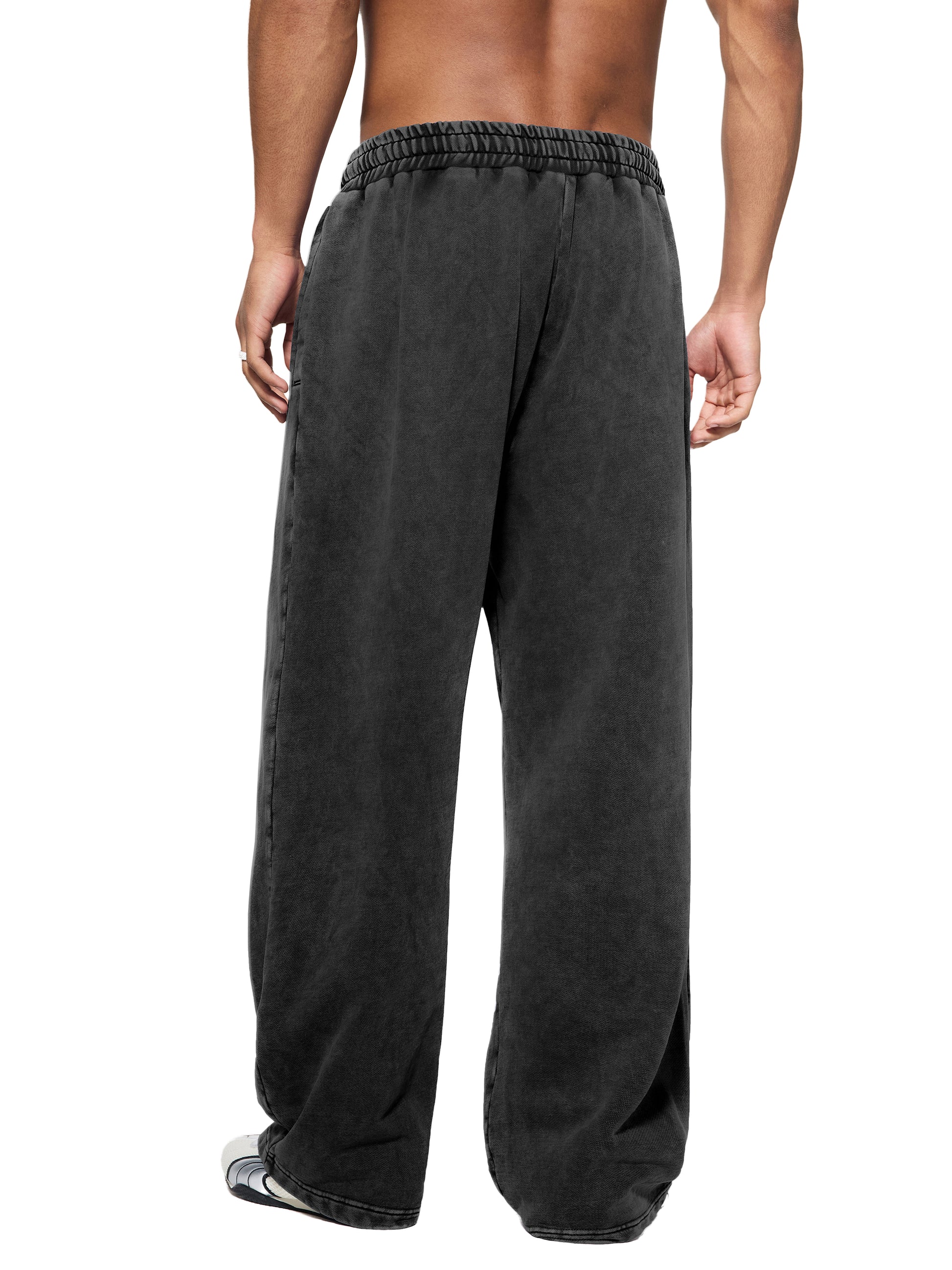 Model wearing baggy straight-leg fleece pants back view