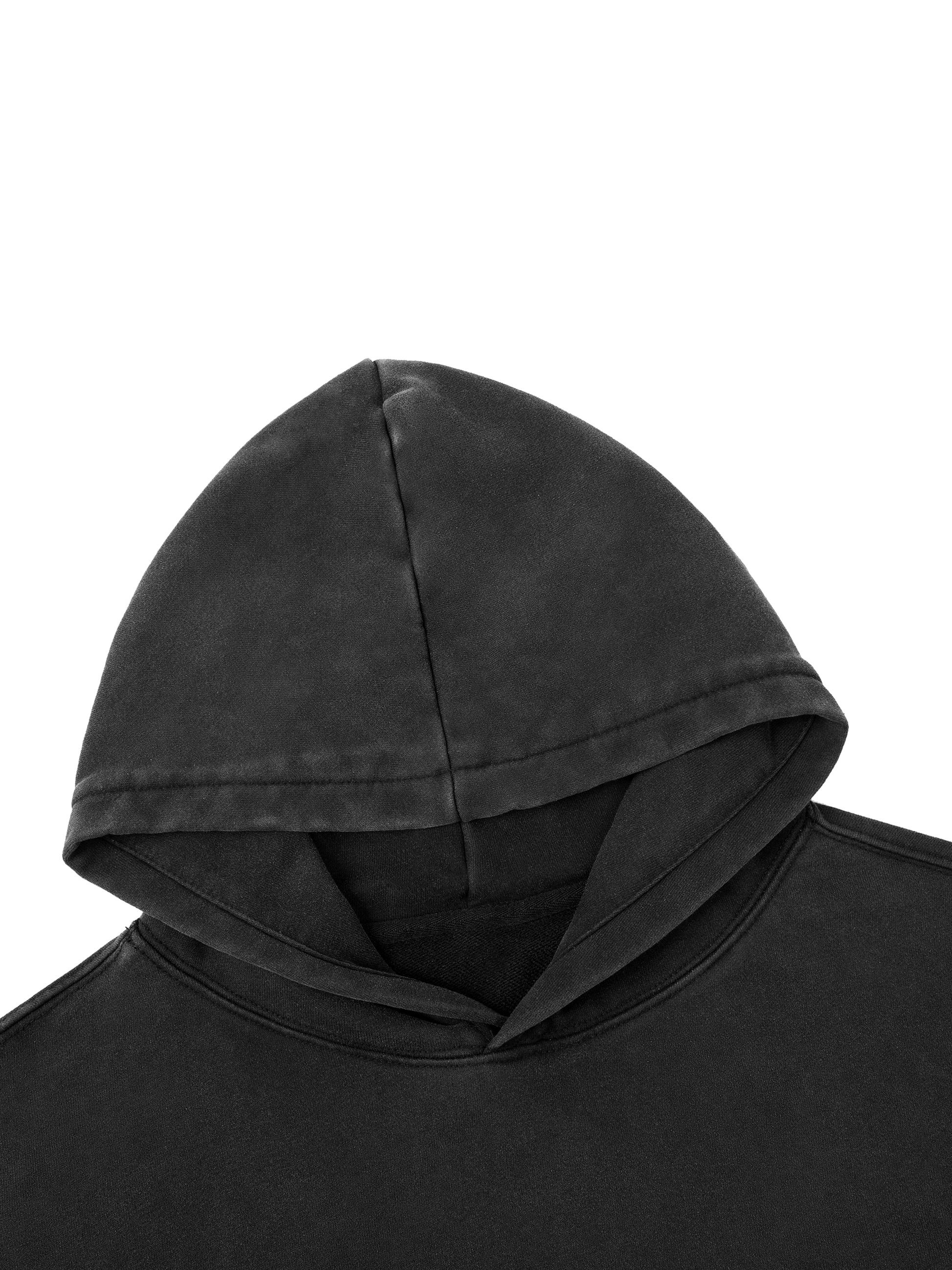 Close up of 400 GSM heavyweight cotton texture with vintage snow wash effect and distressed hem detailing.